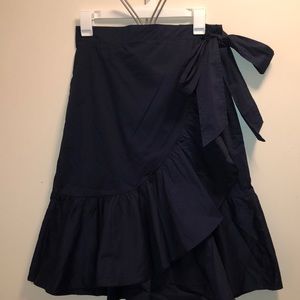 A long navy blue layers skirt with a bow